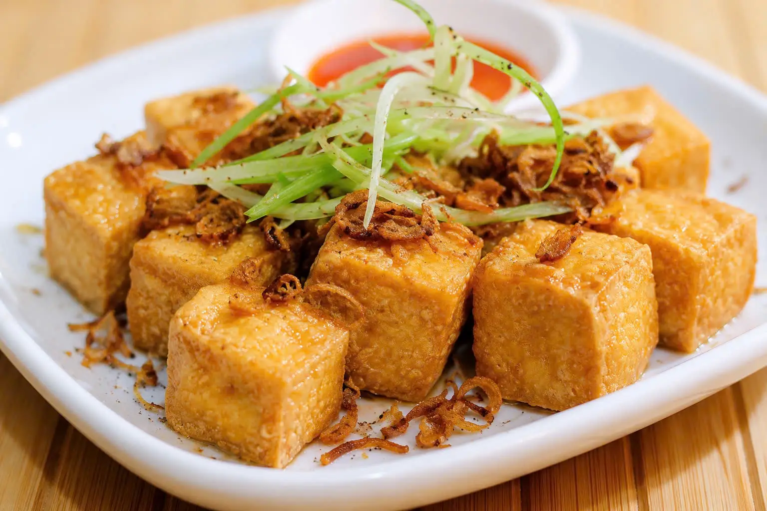 Golden cubes of crispy lemongrass tofu topped with fried shallots and spring onion.