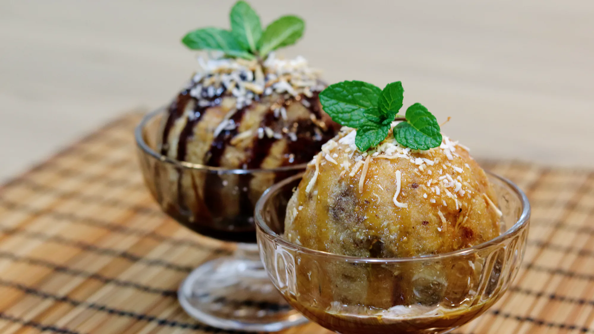 Deep-fried ice cream served with sauce and toasted coconut.