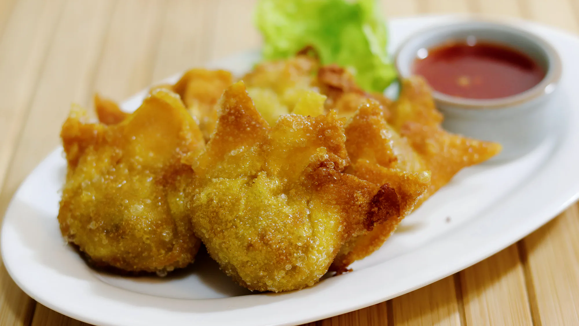 Fried pork wontons served with dipping sauce.
