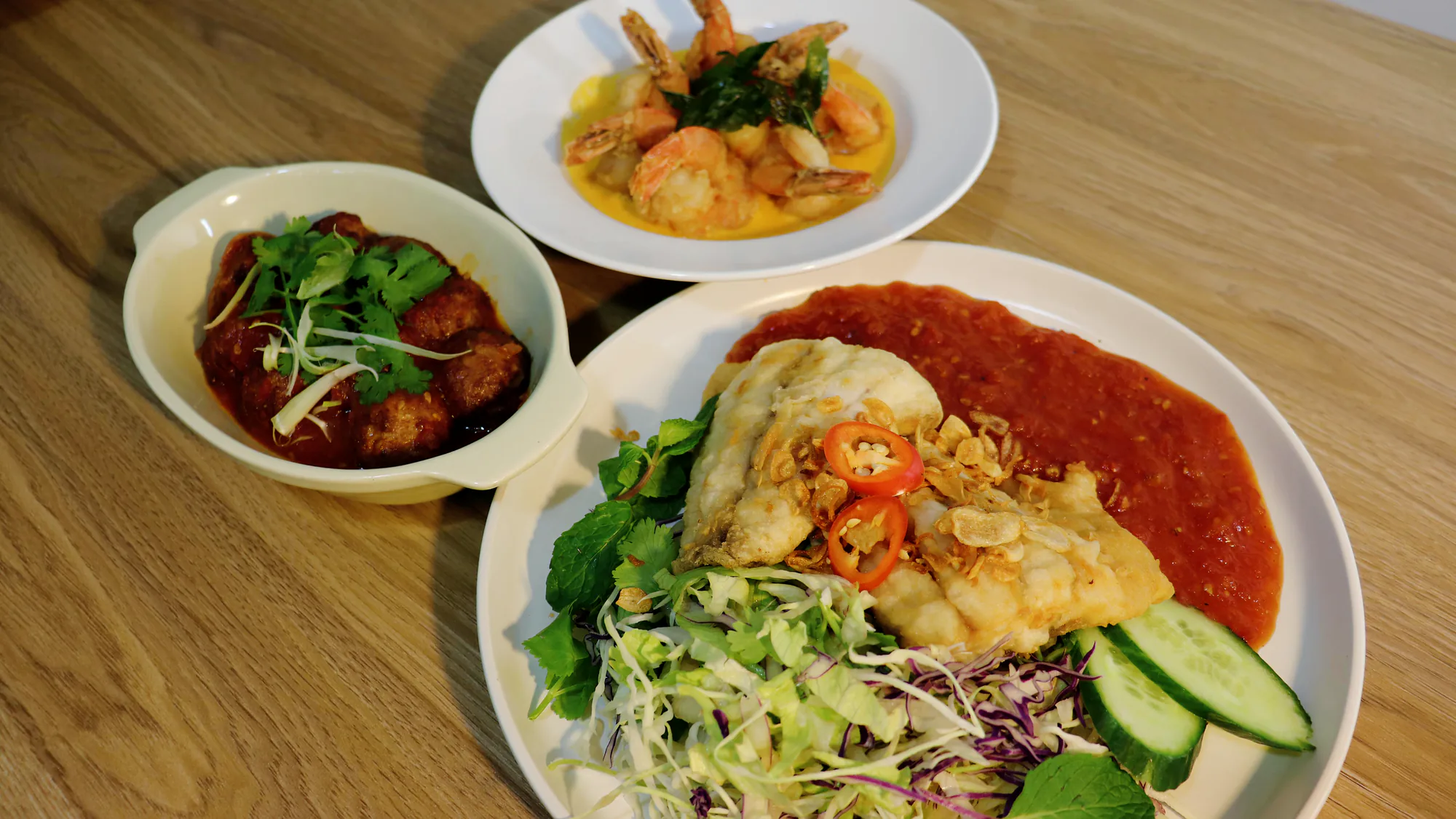 Several Vietnamese dishes arranged across a dining table.