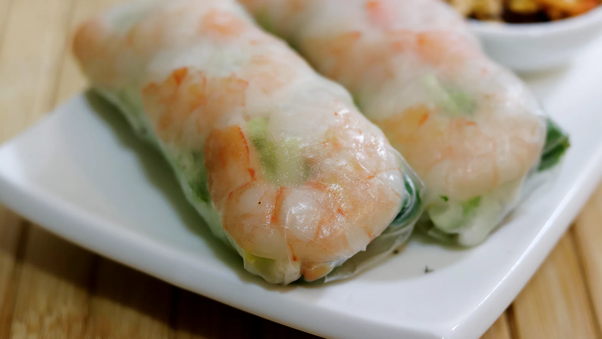 Prawn rice paper rolls served with dipping sauce.