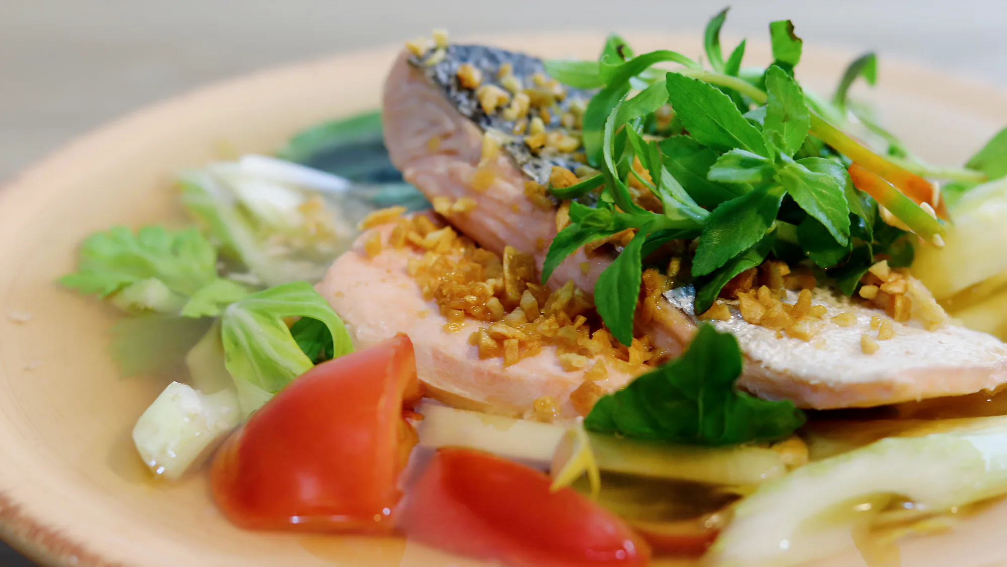 Vietnamese sweet and sour soup served in a shallow bowl.